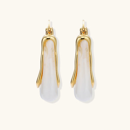 Pair of liquid curve white resin hoop earrings with polished gold-tone frames, front view | Olaty