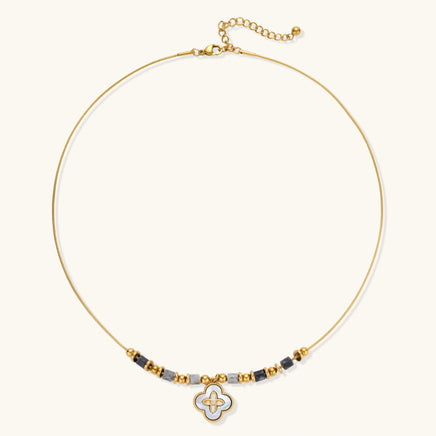 Gold-tone adjustable necklace with grey stone beads and clover-shaped iridescent shell pendant, full view | Olaty