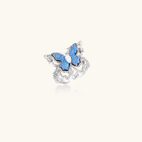 Angled view of blue denim butterfly statement ring with zirconia center and sculptural silver-tone frame | Olaty