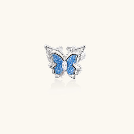 Front view of blue denim butterfly ring with clear zirconia center and sculptural silver-tone detailing | Olaty