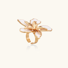 Angled view of white enamel lily statement ring with sculptural gold-tone flower center | Olaty