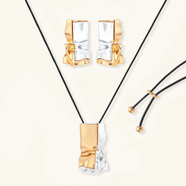 Two-tone sculptural jewelry set with gold and silver abstract earrings and black cord pendant necklace | Olaty