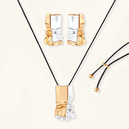 Two-tone sculptural jewelry set with gold and silver abstract earrings and black cord pendant necklace | Olaty