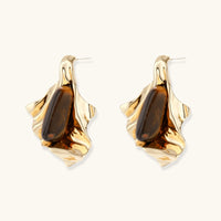 Front view of molten flow statement earrings featuring elongated brown gemstones in fluid gold-tone settings | Olaty