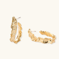Side angle of gold-tone textured hoop earrings showing open hoop shape and post fittings | Olaty