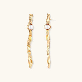 Long gold-tone sculptural drop earrings with flowing organic texture and round white pearl accents | Olaty