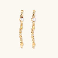 Front view of long gold-tone pearl drop earrings with sculptural twisted wave design | Olaty