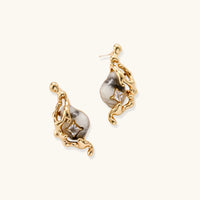 Angled view of sculptural serpent earrings with marbled stone-effect drops and sparkling square zirconia details | Olaty