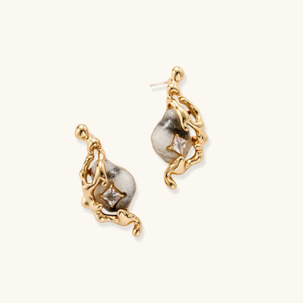 Angled view of sculptural serpent earrings with marbled stone-effect drops and sparkling square zirconia details | Olaty