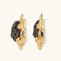 Gold-tone sculptural statement earrings with dark volcanic-style resin and clear rhinestone accents | Olaty