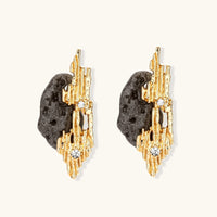 Front view of abstract gold-tone statement earrings with dark resin forms and clear rhinestones | Olaty