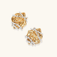 Angled view of dimensional rose stud earrings with organic gold-tone texture and sculptural silver accents | Olaty