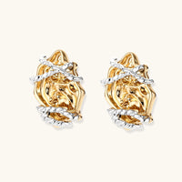 Sculptural floral stud earrings showing raised gold-tone rose forms wrapped with polished silver-tone accents | Olaty