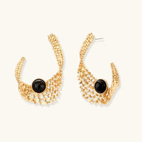 Sculptural gold woven statement earrings with glossy black resin center accents and curved openwork design | Olaty