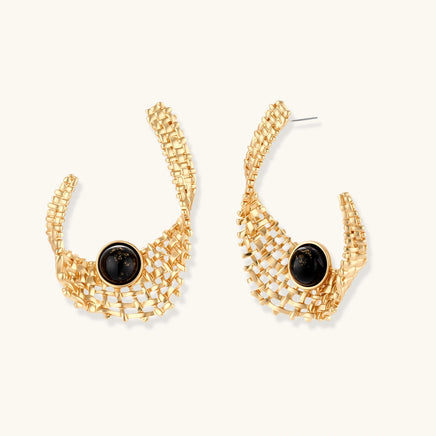 Sculptural gold woven statement earrings with glossy black resin center accents and curved openwork design | Olaty