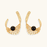 Front view of sculptural gold statement earrings with black resin centers and architectural woven mesh design | Olaty