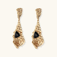Front view of long gold-tone grid earrings featuring triangular black resin centerpieces | Olaty
