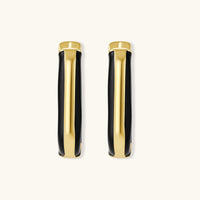 Modern hoop earrings with gold-plated and black sections, featuring hinged closure on white background.