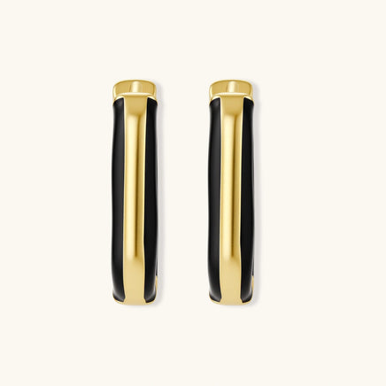 Modern hoop earrings with gold-plated and black sections, featuring hinged closure on white background.