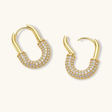 Golden Glow gold huggie hoop earrings with pavé zirconia detailing and hinged closures overhead view | Olaty