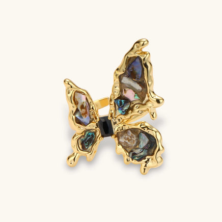 Front angled view of butterfly statement ring with multicolor iridescent shell fragments and gold-tone setting | Olaty