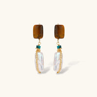 Front view of amber baroque pearl drop earrings with turquoise accents and gold chain details | Olaty