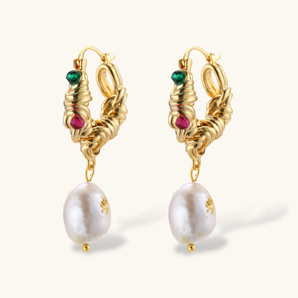 Angled view of textured gold hoop earrings with green and pink gems and pearl drops | Olaty