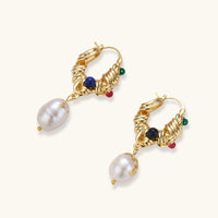 Top view of baroque pearl hoop earrings with sculptural gold detailing and colorful stones | Olaty