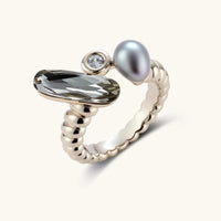 Adjustable copper-plated coffee gold ring with twisted band featuring elongated crystal, round zirconia, and grey pearl.