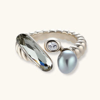 Adjustable copper-plated coffee gold ring with twisted band featuring elongated crystal, round zirconia, and grey pearl.