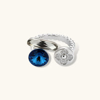 Angled view of adjustable Cosmic Trio ring with blue stone, crystal accent and zirconia flower disc | Olaty