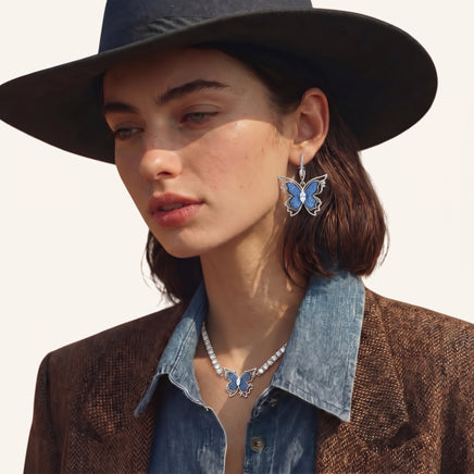 Blue denim butterfly drop earring worn with silver-tone hoop and sparkling zirconia center | Olaty