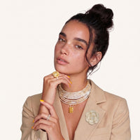 Pearl Rose Statement Brooch styled on a beige blazer with layered ivory petals and pearl-trimmed floral design | Olaty