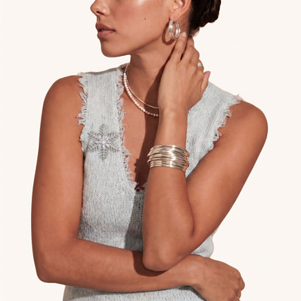 Winter Crystal Snowflake Statement Brooch styled on a light knit top with sparkling clear zirconia details | Olaty