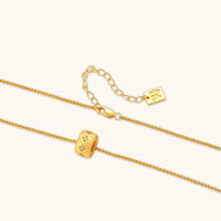 Angled view of Stardust ring pendant necklace with textured gold finish, crystal details and adjustable chain | Olaty