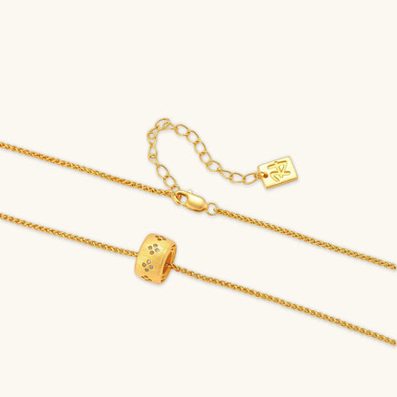 Angled view of Stardust ring pendant necklace with textured gold finish, crystal details and adjustable chain | Olaty