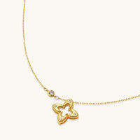 Angled view of Blooming Star open petal necklace with textured gold pendant and round sparkling accents | Olaty