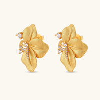 Angled pair of Bloom floral stud earrings with textured gold petals and cubic zirconia swirls | Olaty