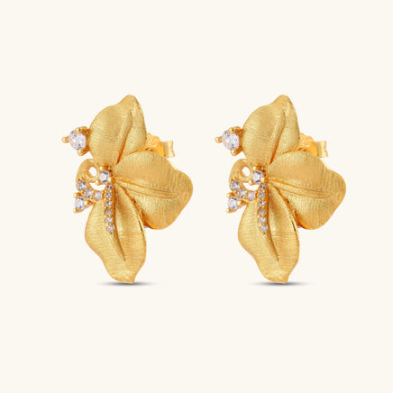 Angled pair of Bloom floral stud earrings with textured gold petals and cubic zirconia swirls | Olaty
