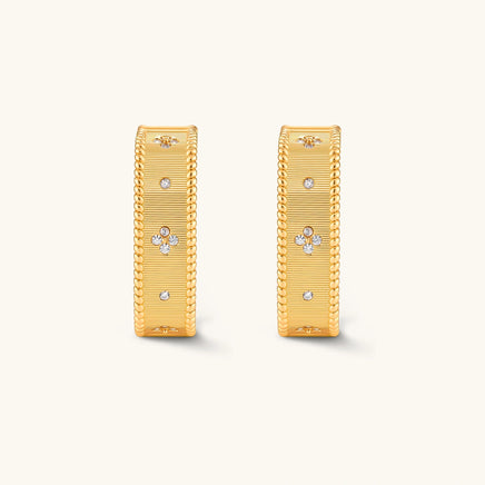 Front view of matching baroque ribbed gold huggie hoop earrings with delicate floral accents | Olaty