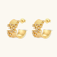 Angled view of Stardust Scatter Hoop Earrings featuring wide curved gold surfaces and sparkling cubic zirconia details | Olaty