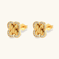 Angled pair of braided clover stud earrings with brushed gold texture and round cubic zirconia halo | Olaty