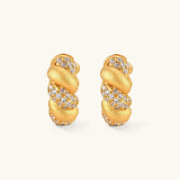 Front view of braided pavé huggie hoop earrings with alternating brushed gold and cubic zirconia sections | Olaty