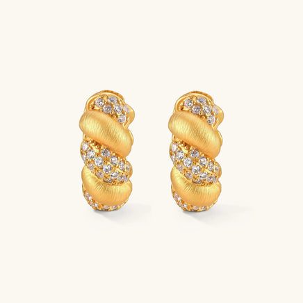 Front view of braided pavé huggie hoop earrings with alternating brushed gold and cubic zirconia sections | Olaty