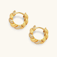 Open braided pavé huggie hoop earrings showing twisted design, cubic zirconia accents and hinged closures | Olaty