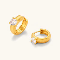 Brushed solitaire huggie hoop earrings with round cubic zirconia stones and visible hinged closures | Olaty