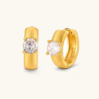 Brushed solitaire huggie hoop earrings with round cubic zirconia stones in a front and angled product view | Olaty