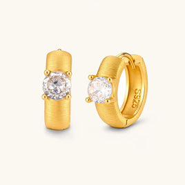 Brushed solitaire huggie hoop earrings with round cubic zirconia stones in a front and angled product view | Olaty
