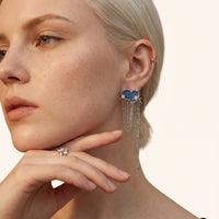 Close-up of blue denim heart statement earring with sparkling star details and long silver-tone chain drops | Olaty