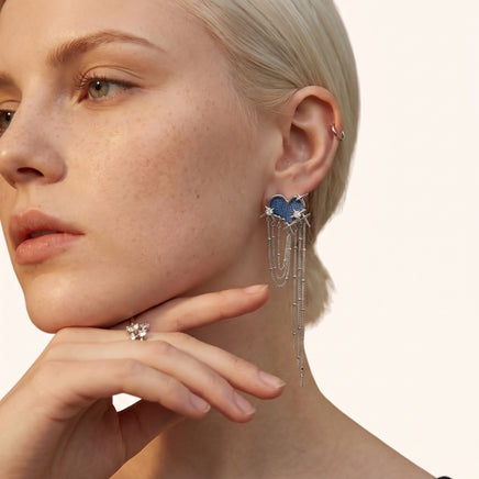 Close-up of blue denim heart statement earring with sparkling star details and long silver-tone chain drops | Olaty